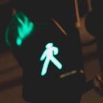 An electronic crosswalk sign at night.